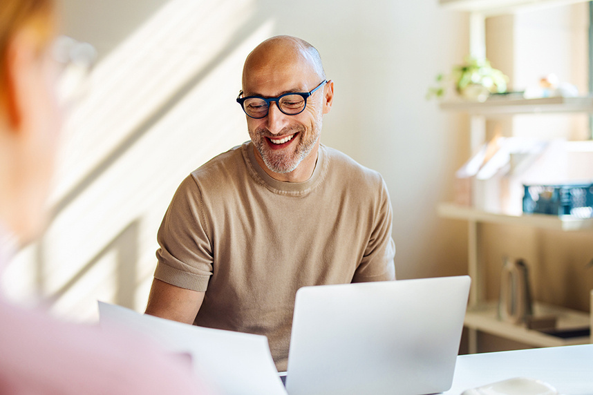 man sitting at desk with computer