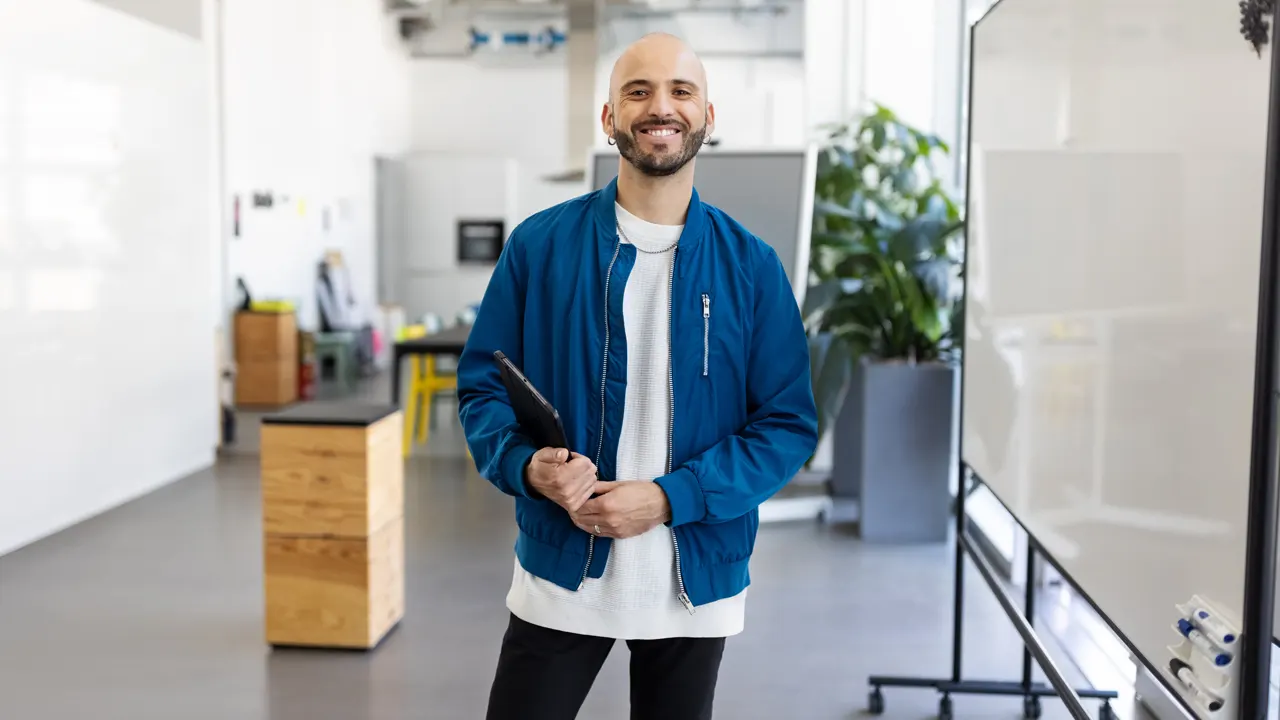 Photo of a smiling man in casual office setting